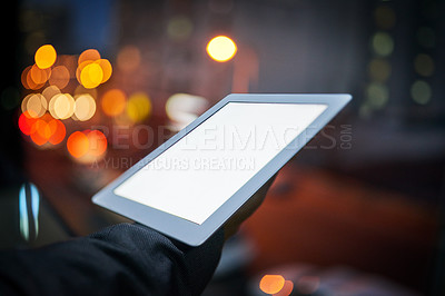 Buy stock photo Cropped shot of a businessman using a digital tablet at night