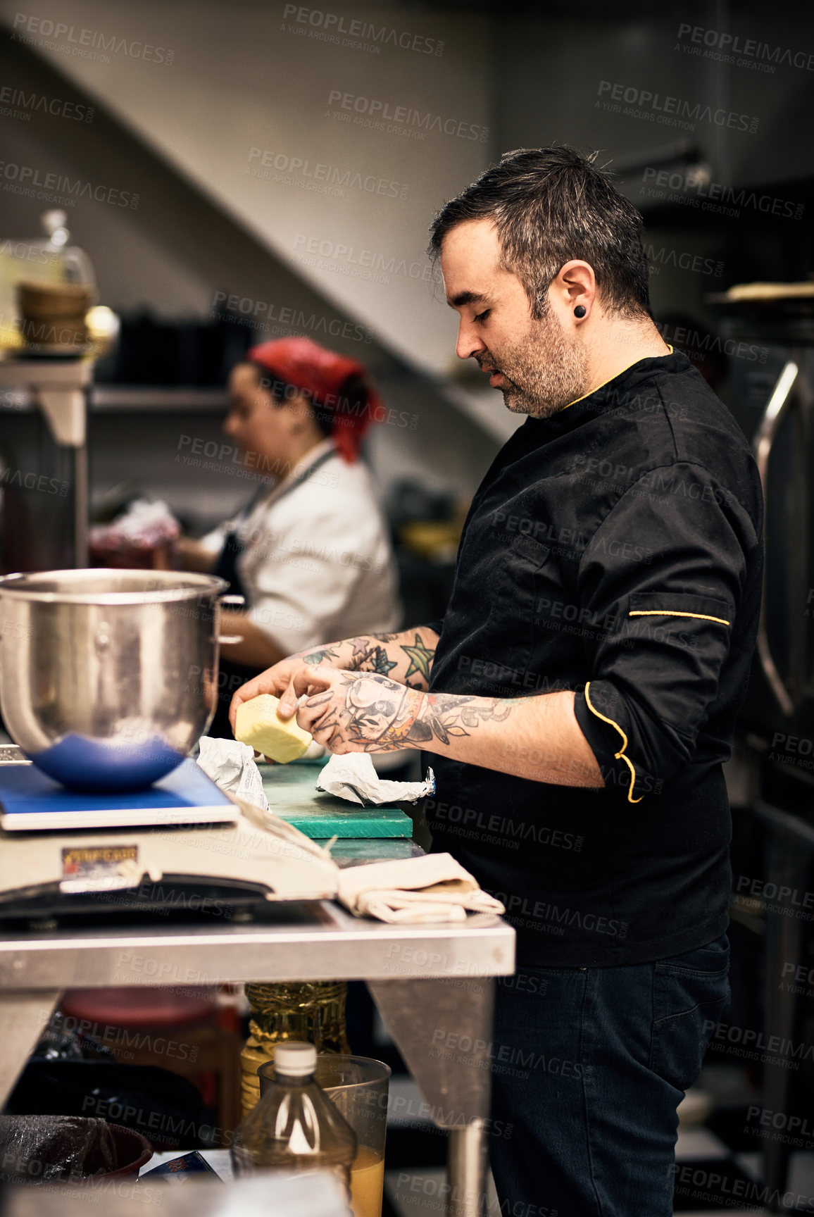 Buy stock photo Shot of a focused chef preparing a dish in the kitchen of a restaurant