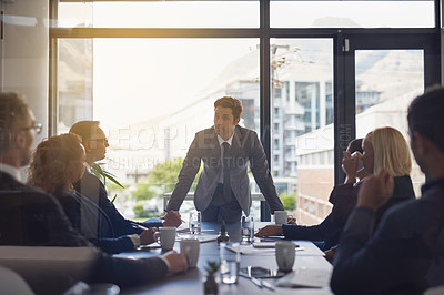 Buy stock photo Shot of a group of businesspeople having a meeting together in a boardroom at the office