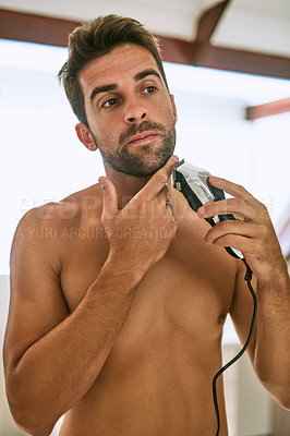 Buy stock photo Man, beard and shave with electrical razor for hair removal, aesthetic skincare and beauty cleaning in morning at home. Shirtless guy shaving face with blade, trimmer and cosmetic tools in bathroom