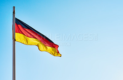 Buy stock photo Low angle shot of the German flag standing on its own outside during the day