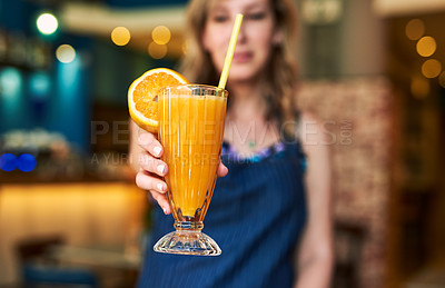Buy stock photo Cropped shot of a waitress holding out a drink at a bar