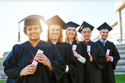 Buy stock photo Portrait of a group of students standing in a line on graduation day