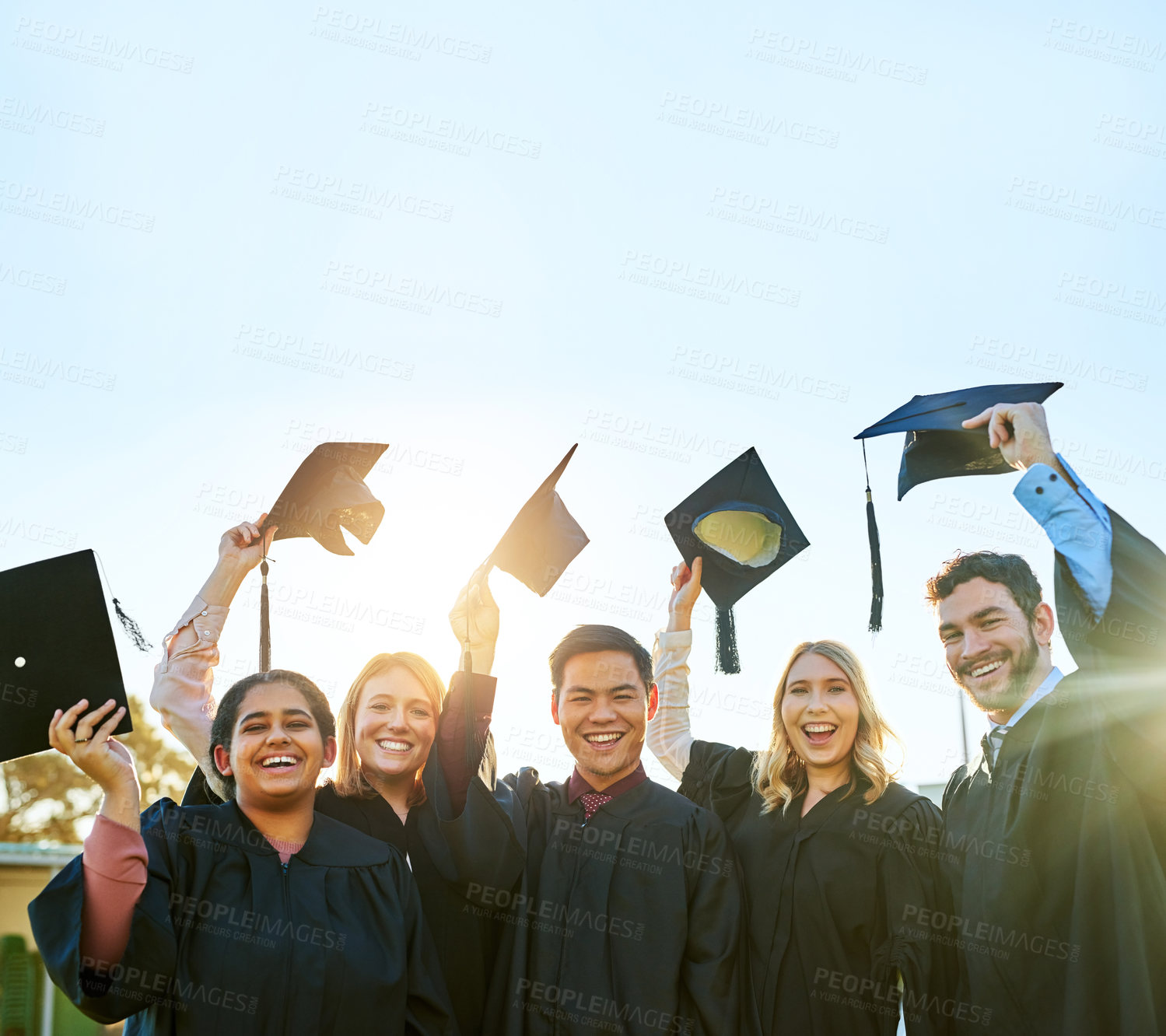 Buy stock photo Portrait of a group of students celebrating on graduation day