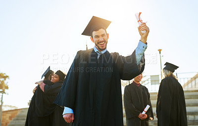 Buy stock photo Portrait of a student holding his diploma on graduation day