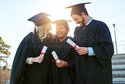 Buy stock photo Shot of a group of students holding their diplomas on graduation day