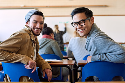 Buy stock photo Rearview portrait of two young male university students sitting in class during a lecture