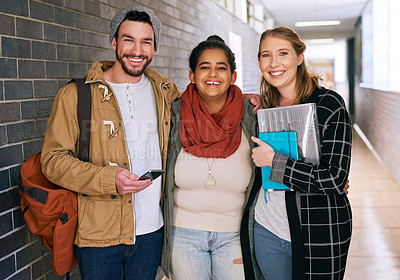 Buy stock photo Cropped portrait of three young university students standing in a corridor on campus