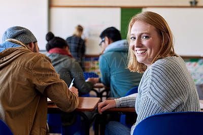 Buy stock photo Rearview portrait of a young female university student sitting in class during a lecture