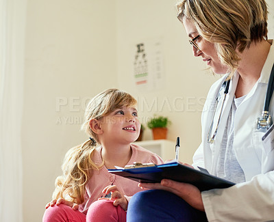 Buy stock photo Shot of a doctor having a consultation with a little girl in her consulting room
