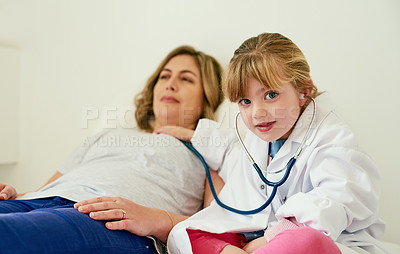 Buy stock photo Portrait of an adorable little girl dressed up as a doctor and examining a woman with a stethoscope