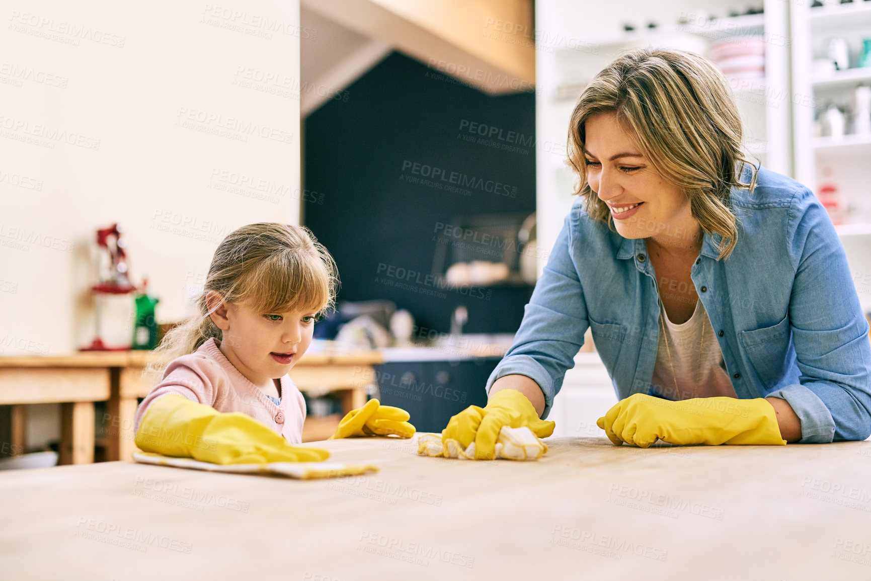 Buy stock photo Cleaning, learning and mother with child for wipe counter in home for bonding, development or growth. Rubber gloves, housekeeping and mom teaching girl kid to wash table for germs, bacteria or dirt.