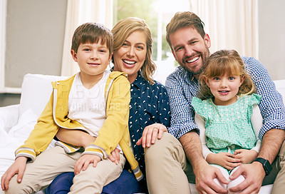 Buy stock photo Shot of a family sitting on the sofa at home