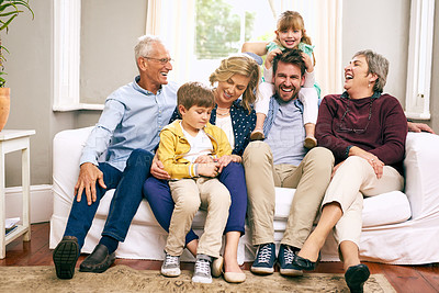Buy stock photo Shot of a multigenerational family sitting on the sofa at home