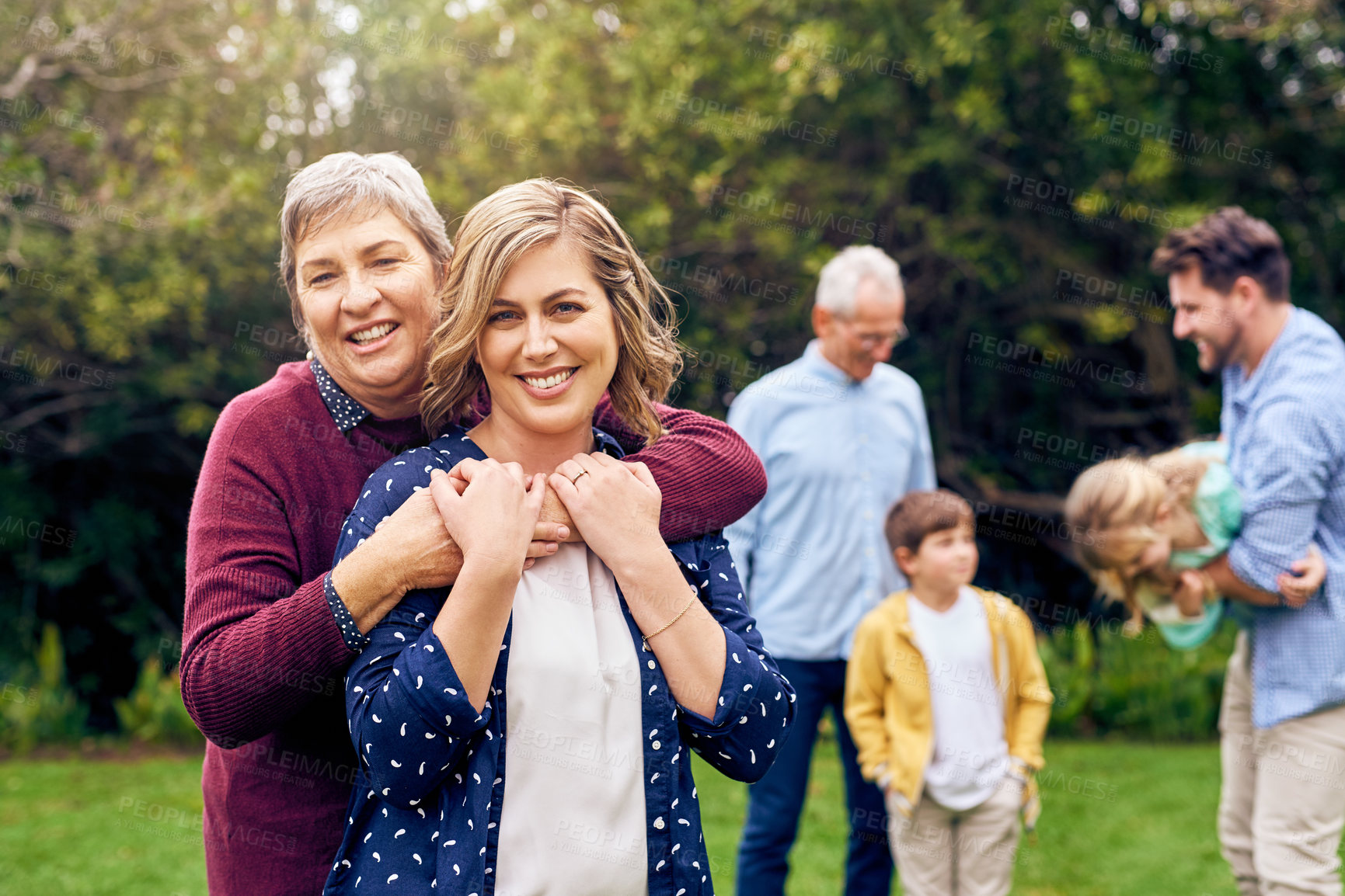 Buy stock photo Hug, portrait of woman and mother in garden with big family for bonding, love or visit in summer. Backyard, happy or smile with senior person and daughter embracing outdoor for support or wellness