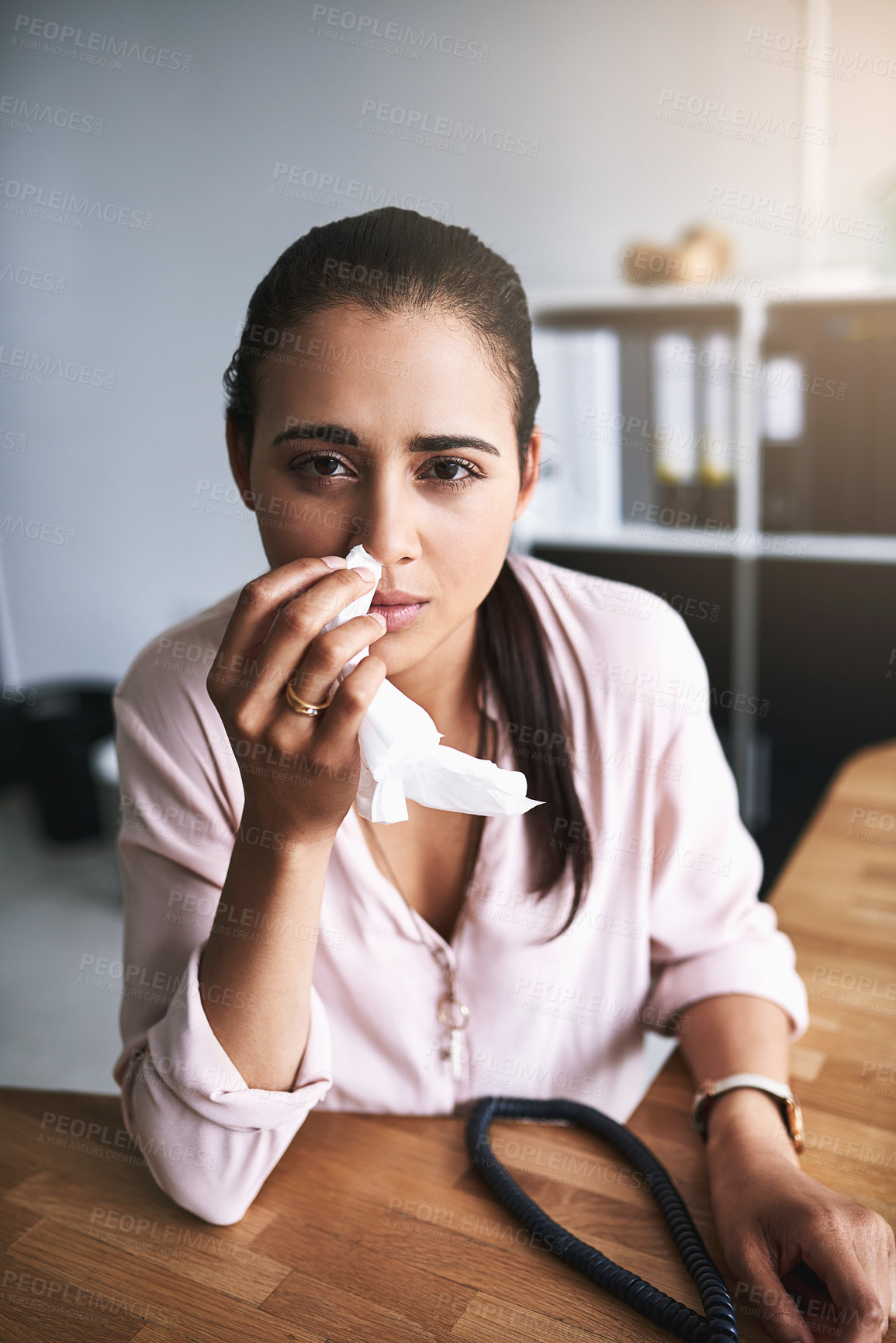 Buy stock photo Portrait of a young businesswoman blowing her nose in an office