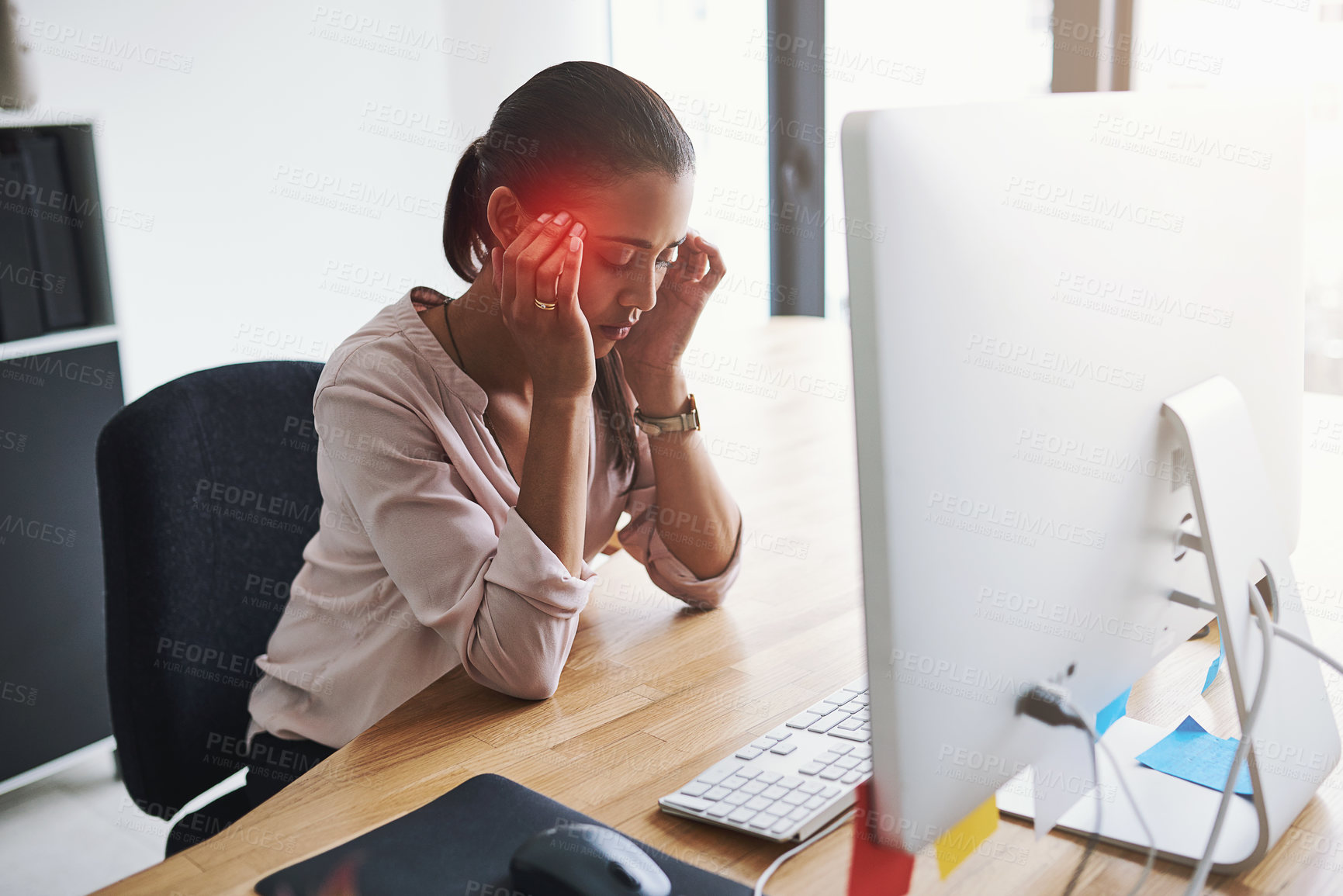 Buy stock photo Shot of a young businesswoman suffering with a headache while working in an office