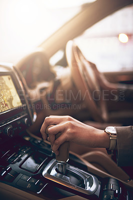 Buy stock photo Shot of an unidentifiable businesswoman changing the gears while driving a car