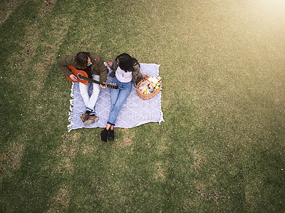 Buy stock photo High angle shot of a young couple having a romantic date in the park