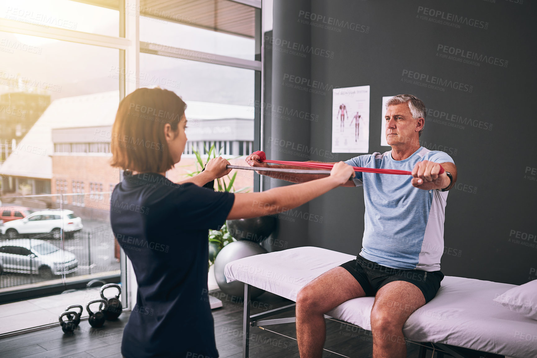 Buy stock photo Physiotherapist, senior man and band for stretching at clinic, rehabilitation and specialist for help. Woman, chiropractor and patient for injury consultation, orthopedic and support with treatment