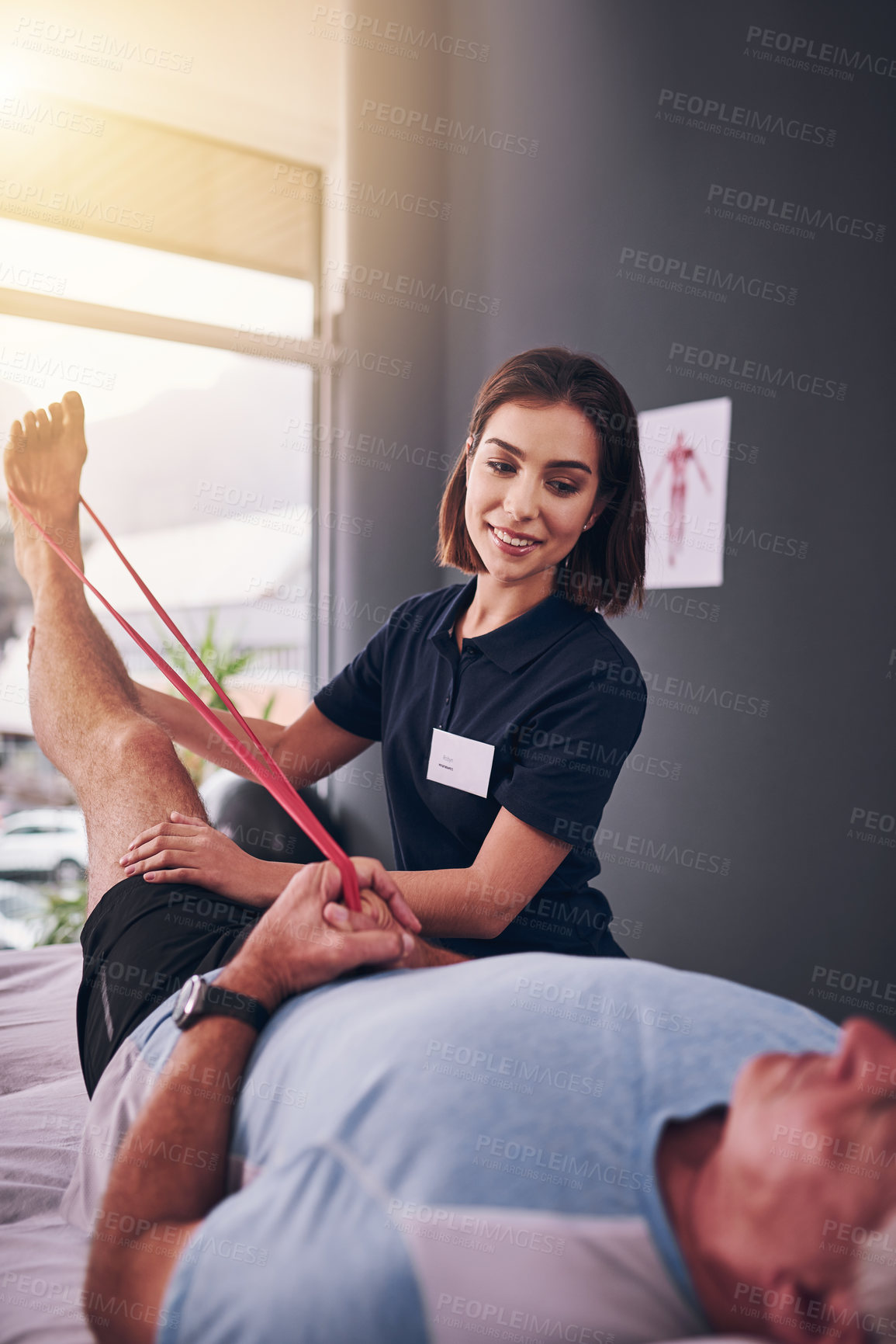 Buy stock photo Physiotherapist, resistance band and woman with recovery, consultation for injury, expert or patient. Help, physical therapy and client with rehabilitation exercise or stretch leg for muscle strength