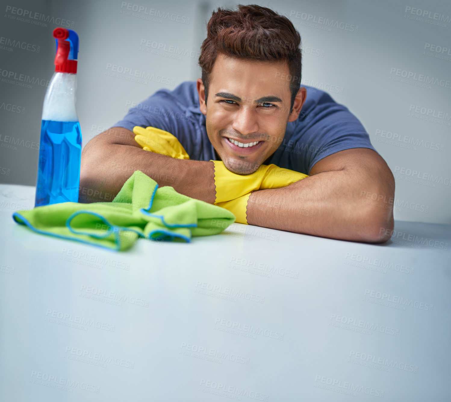 Buy stock photo Shot of a young man doing household chores