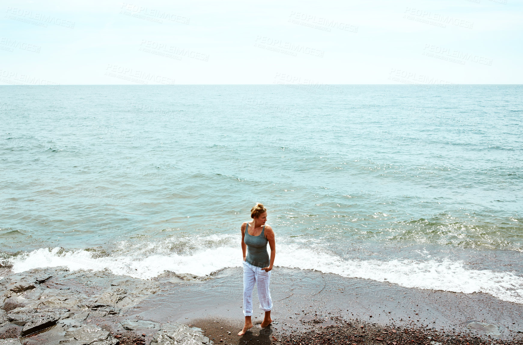 Buy stock photo Walking, vacation and woman on beach for peace, weekend break or tropical destination for abroad getaway. Space, travel adventure or person by ocean for holiday, high angle or tourist trip in Morocco