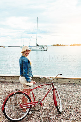 Buy stock photo Portrait, travel or woman with bicycle by ocean with smile, commute and adventure on vacation. Bike, cycling or happy girl by sea outdoor on trip with vintage transport on holiday by harbor in France