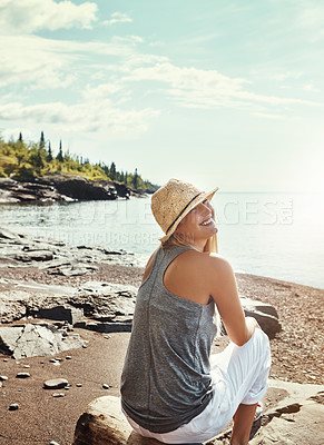 Buy stock photo Woman, smile and relax at lake for vacation, freedom or outdoor adventure in nature with trees. Female person, happiness and calm peace by water for travel in Canada, wellness holiday with hat