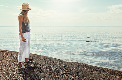 Buy stock photo Shot of a young woman spending a day at the lake