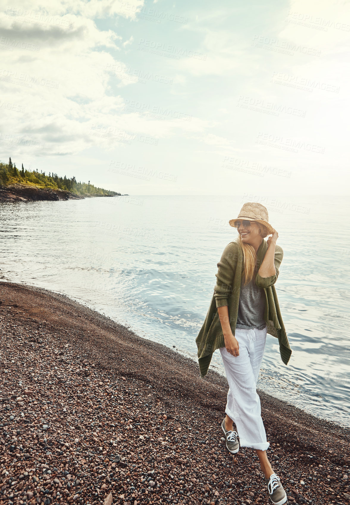 Buy stock photo Happy woman, walking or beach with hat for summer holiday, weekend getaway or travel in nature. Female person, traveler or trip with smile or sunshine on ocean coast for fresh air or outdoor vacation