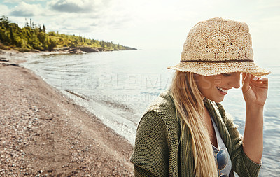 Buy stock photo Shot of a young woman spending a day at the lake