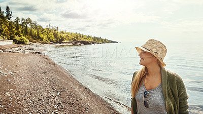 Buy stock photo Shot of a young woman spending a day at the lake