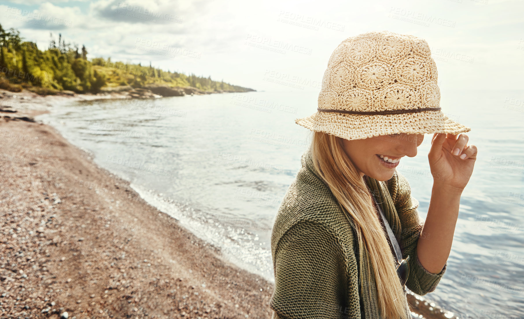 Buy stock photo Beach, holiday and woman with hat, laugh and thinking on adventure, tourism and fresh air on getaway. Outdoor, traveler and person with smile in nature, reflection and break on vacation, sea or space