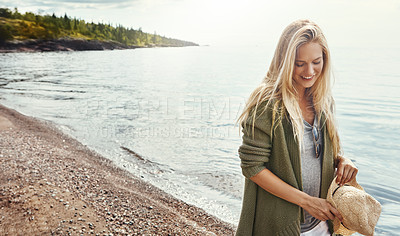 Buy stock photo Shot of a young woman spending a day at the lake