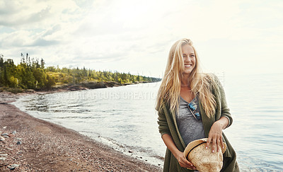 Buy stock photo Shot of a young woman spending a day at the lake