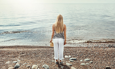 Buy stock photo Shot of a young woman spending a day at the lake