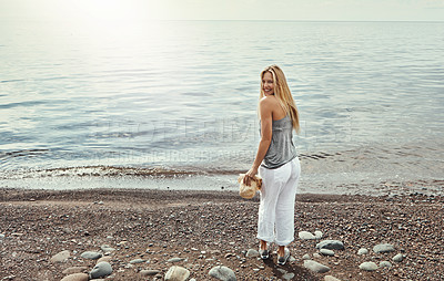 Buy stock photo Shot of a young woman spending a day at the lake