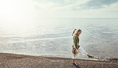 Buy stock photo Shot of a young woman spending a day at the lake