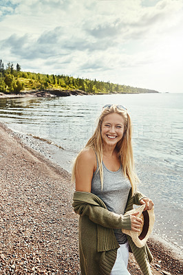 Buy stock photo Shot of a young woman spending a day at the lake