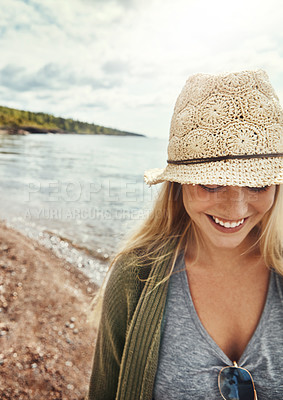 Buy stock photo Shot of a young woman spending a day at the lake