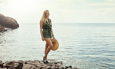 Buy stock photo Shot of an attractive young woman spending a day at the lake