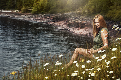 Buy stock photo Shot of an attractive young woman spending a day at the lake