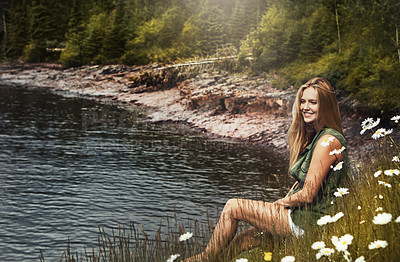 Buy stock photo Shot of an attractive young woman spending a day at the lake