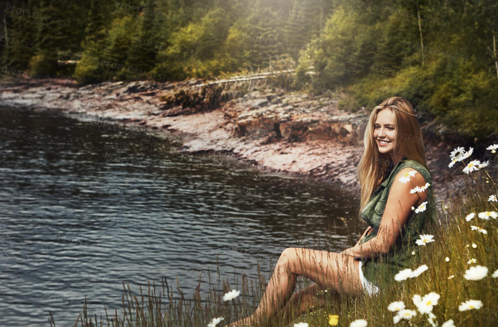 Buy stock photo Shot of an attractive young woman spending a day at the lake