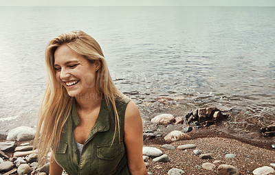 Buy stock photo Shot of an attractive young woman spending a day at the lake