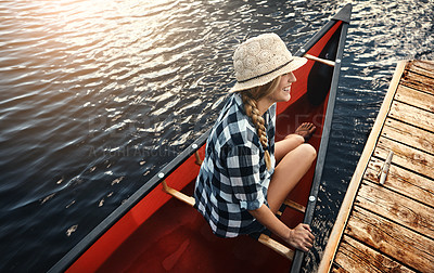 Buy stock photo High angle of an attractive young woman spending a day kayaking on the lake