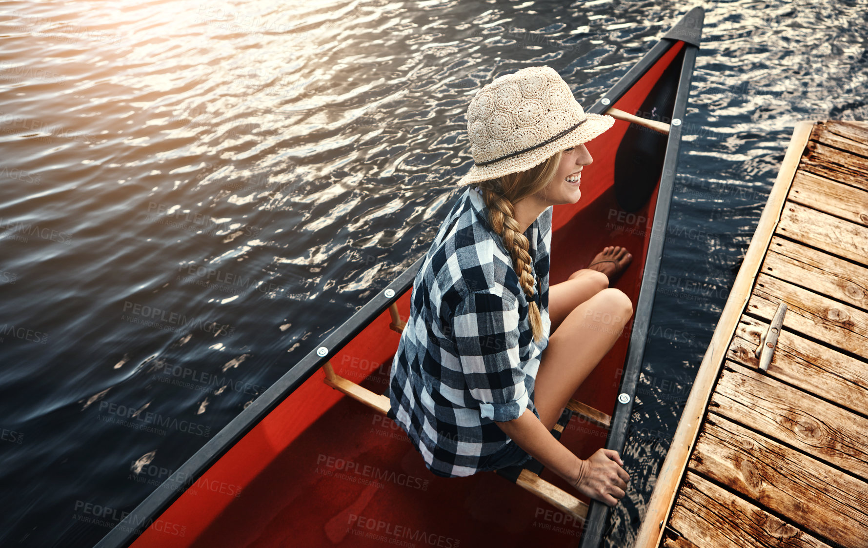 Buy stock photo High angle of an attractive young woman spending a day kayaking on the lake