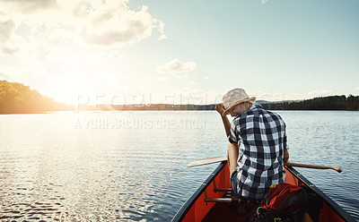 Buy stock photo Shot of an attractive young woman spending a day kayaking on the lake