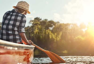 Buy stock photo Shot of an attractive young woman spending a day kayaking on the lake